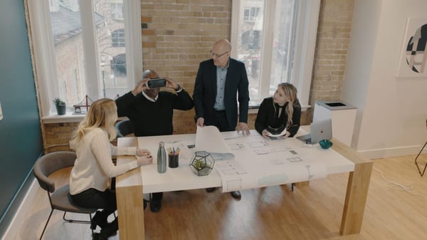 Clients taking turns looking through the VR headset