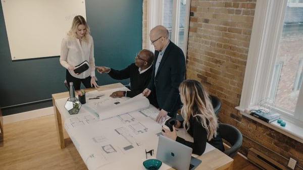 People around a table with VR headsets 