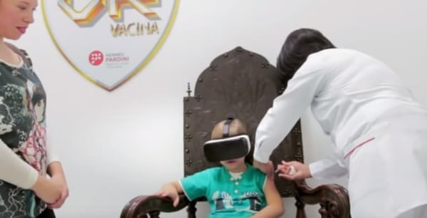 Child getting injection and wearing a VR headset