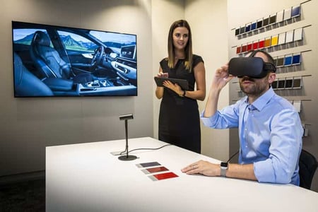 Man wearing VR headset customizing his car